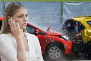 woman on phone in front of rear-end accident