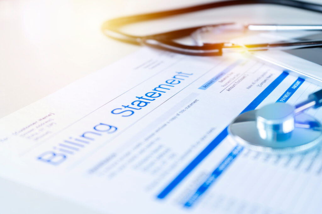 Health care billing statement with stethoscope, bottle of medicine for doctor's work in medical center stone background.